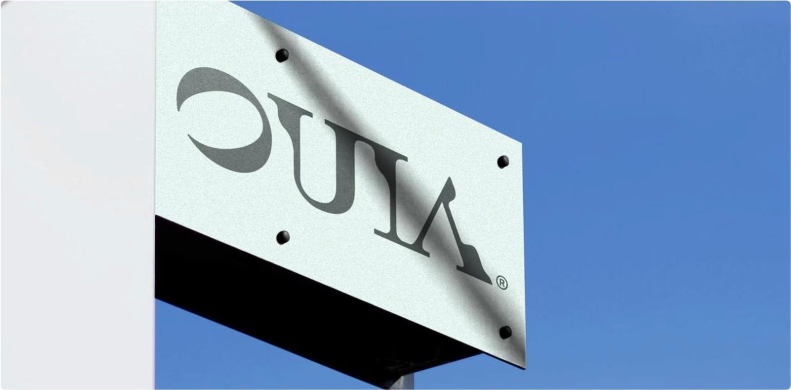 OUIA outdoor sign against a blue sky