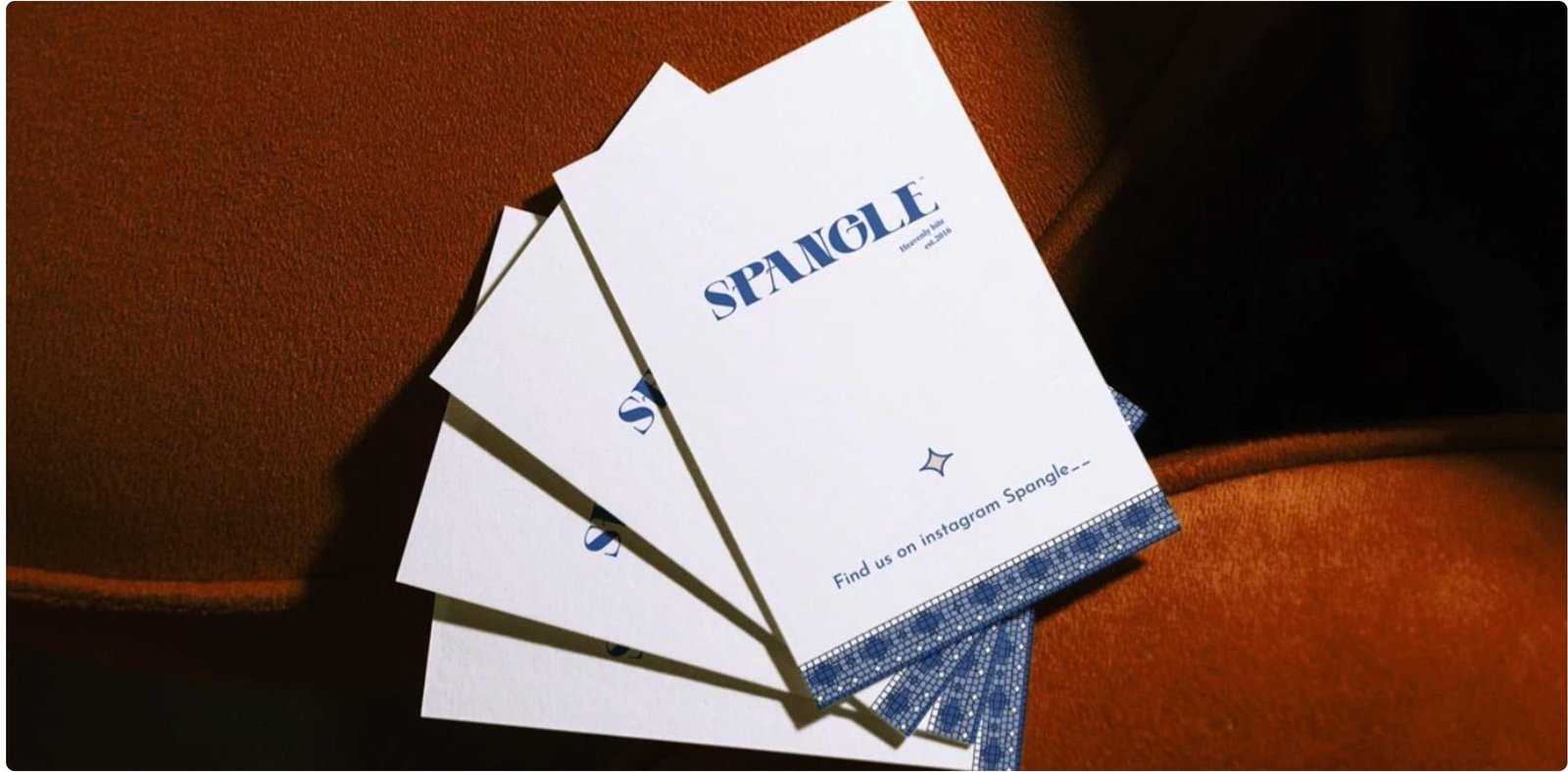 Spangle brand cards on terracotta fabric